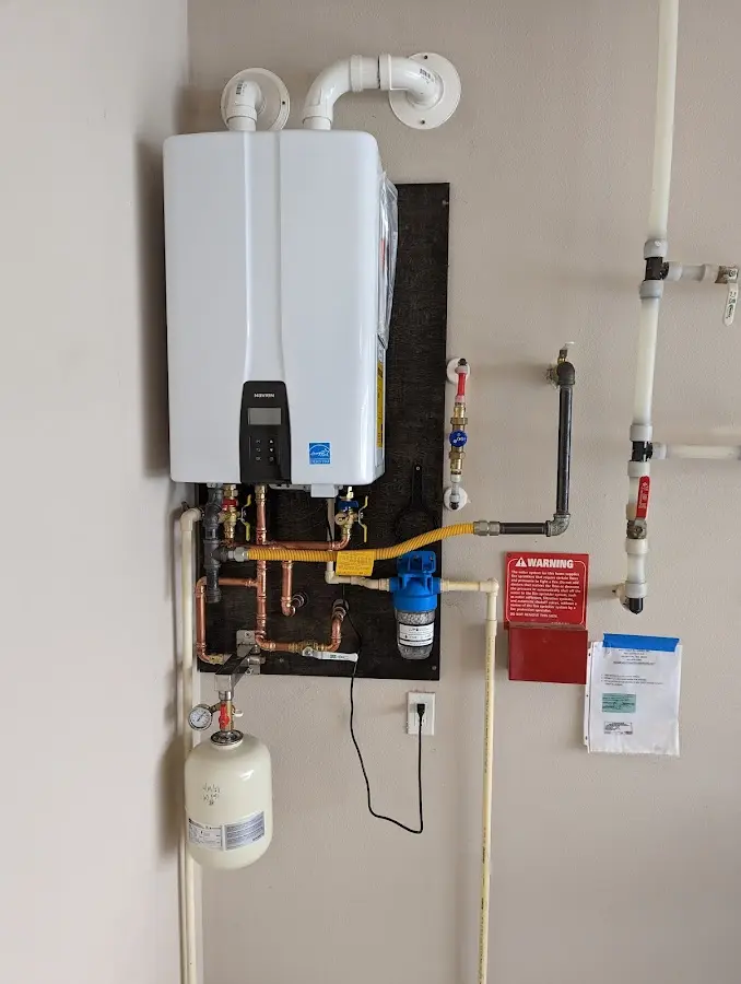 Professional plumber installing copper piping in a Weaver home